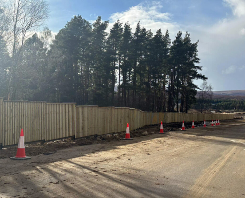 Timber acoustic barrier installed beside construction route near Tomatin