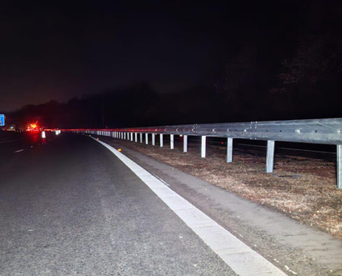 Completed VRS barrier installation along trunk road carriageway at night