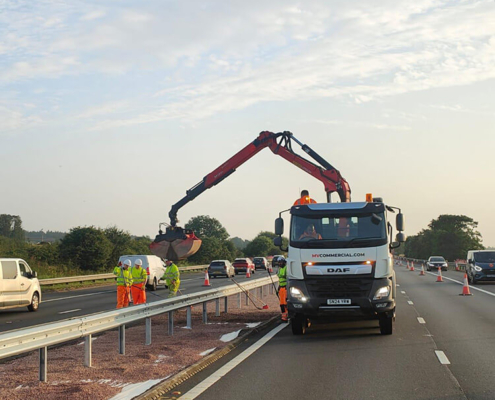 Operatives installing new vehicle restraint system barrier on trunk road works
